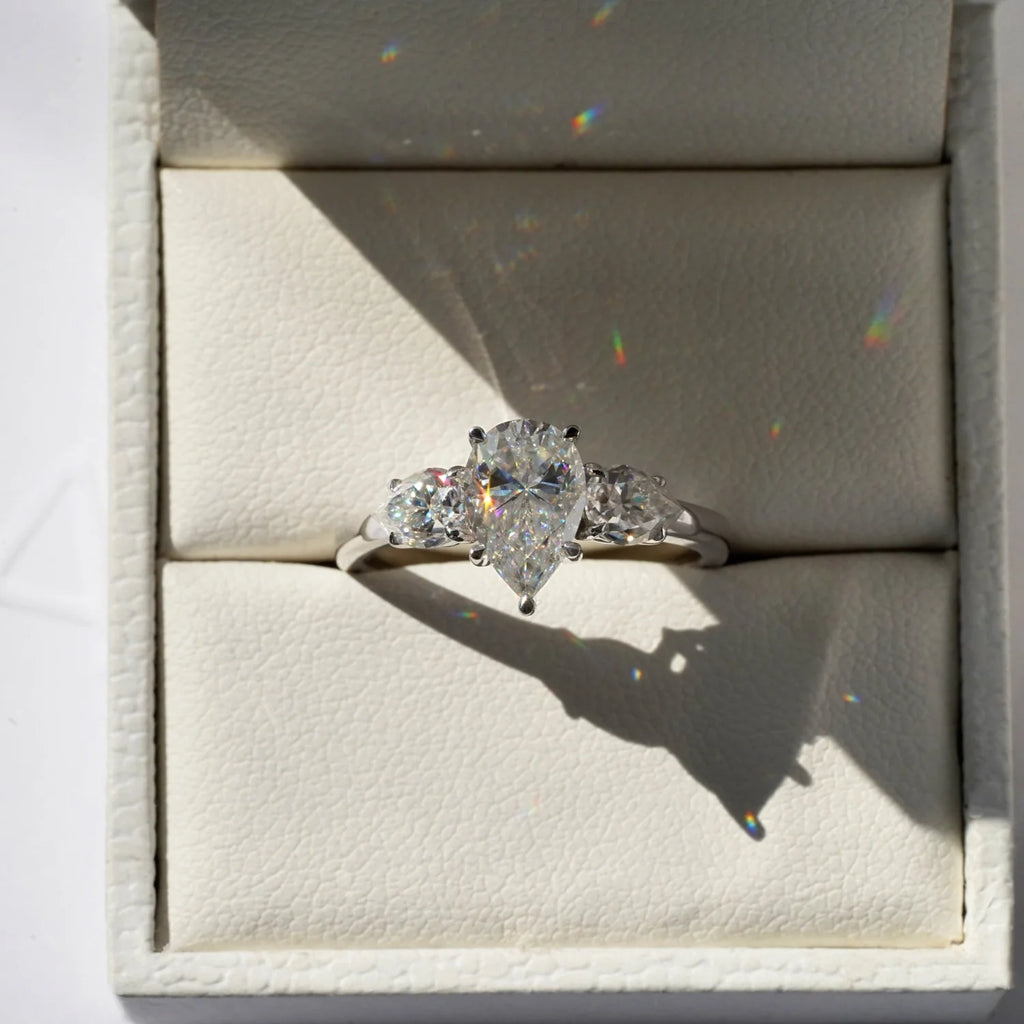 Pear Shaped Moissanite Ring with Two Side Stones